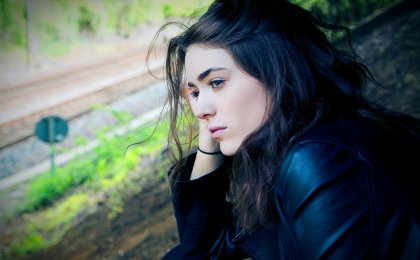 Young woman looking pensive and introspective, symbolizing emotional struggle
