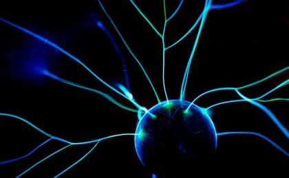 Electric blue plasma energy radiating from a central sphere, symbolizing brain activity