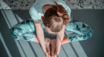 Woman in butterfly pose practicing yoga for heart and hormonal health